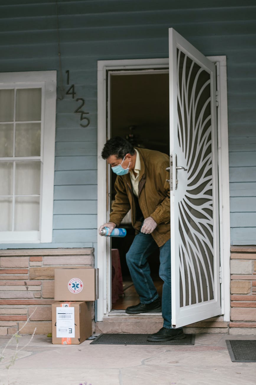 a man disinfecting his packages