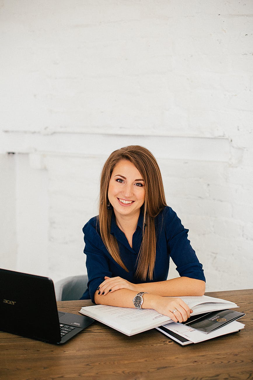 woman in blue long sleeve shirt sitting on chair